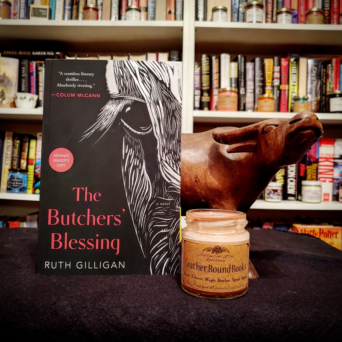 The Butchers' Blessing by Ruth Gilligan , a white lined artistic drawing of half a cow's face on a black background.